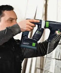 Person using Hardcore No Fuss Cordless Construction Screwdriver With Brushless Motor Tech for fastening wood planks.