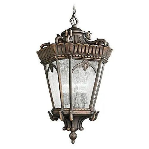 Victorian 4 Light Outdoor Pendant Light In Textured Black Finish With Clear Seeded Glass Panels hanging from a chain, showcasing ornate detailing.
