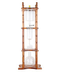 Slick Cold Brew Coffee Tower Featuring A Reliable Ice Drip System For Bold Flavor Kick Holds A Humongous 3000ML Glass Jar Settled On A Raw Brown Wood Stand