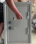 Person using Heavy Duty Door Hinge Gap Adjuster Tool With Double Head Pro Grade Steel Spanner For Easy Hinge Fixes Portable Heavy Duty Door Tool 8.5 To 17.5mm Small Gap Compatibility 2025 Upgrade on a small grey door.