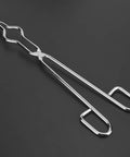Top Tier Heavy Duty Stainless Steel Crucible Tongs With Non Slip Paws And Rock Solid Beaker Clamps For Zero Sweat High Heat Chemistry Lab Tasks Daily Featuring Aircraft Class Rivet Construction angled view on dark background.