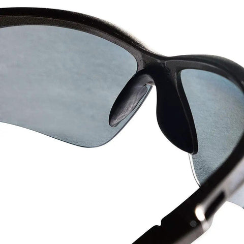 Heavy Duty Safety Glasses With Hard Coated Anti Scratch Polarized Lenses For Crisp Vision And Slip On Fit Ansi Z87 Certified Eye Protection That Handles The Daily Grind Pack Of 12 For Work Sites close-up view showing smoke lenses and frame detail.