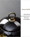 Solid Vintage Black Ceramic Tea Storage Jar With Tight Seal Airtight Lid showing bronze pull ring for easy access.