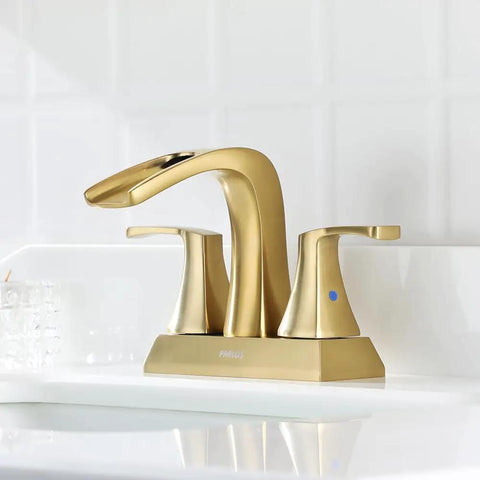Waterfall Spout Two Handle Bathroom Faucet With Oil Rubbed Bronze Finish Includes Metal Pop Up Drain And Faucet Supply Lines 4 Inch Centerset For Three Hole Sinks No Fuss Durable Tarnish Scratch And Corrosion Resistant Doris 14069. Featuring a sleek gold appearance on a white sink.