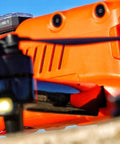Close-up of an orange drone with an Arc V Pro Grade Multi Color Drone Strobe With Remote Control attached on top.