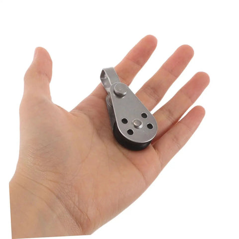 Single stainless steel pulley block held in hand, part of 4pc set for kayak and boat anchor, heavy duty marine grade use
