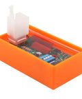Close-up of 5 Pin AC CDI Motorcycle Ignition Box With Dip Switch For 4 Stroke Models, orange unit showing internal components.