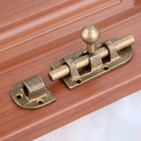 Heavy Duty Bronze Brass Door Slide Bolt With Vintage Barrel Catch Latch For Secure Cabinet Drawer Window Closure Tough Heavy Metal That Stays Put And Installs Without A Hitch At 105 X 33mm on wooden background
