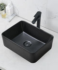 Modern black rectangular vessel sink with faucet on marble countertop