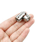 Heavy Duty 10mm Inner Bore Steering Shaft U Joint Universal Joint For RC Cars And Small Machinery, 16 x 34mm Outer Diameter And 34mm Length, 10mm Bore, Metal Coupling For Smooth Torque Transmission And Rock Solid Alignment. Nickel-coated iron RC shaft joint in hand