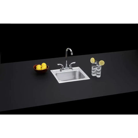 Drop-In 15x15 Inch Single Bowl Stainless Steel Bar Sink With Faucet Kit installed in a modern countertop setup with lemons and glass.