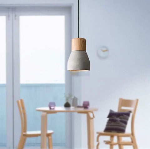Cool Concrete Pendant Light For Dining Room And Kitchen Bar Nordic Industrial Hanging Light Fixture in gray above dining table.