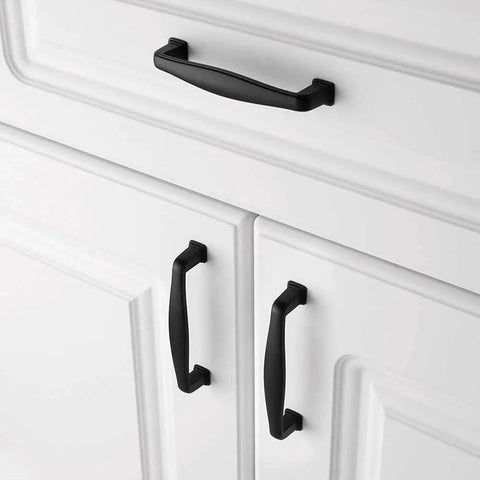 Grab These Sick Matte Black Cabinet Pulls Perfect For Any Renovation Vibe 10 Pack Of Rock Solid Drawer Handles with smooth rounded edges on white cabinet.