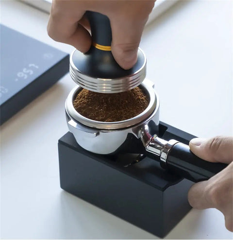 Solid Kickass Coffee Tamping Station With Integrated Espresso Scale Base, tamping coffee grounds in portafilter.