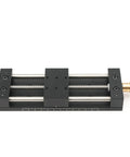 Built Tough Aluminum Manual Sliding Table Actuator with black coating and threaded feet for precise linear motion.