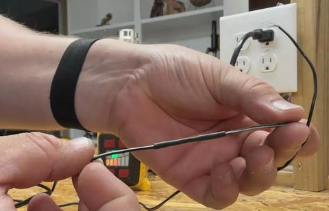 Person using Top Shelf Heavy Duty Adhesive Lined Heat Shrink Tubing Kit, showcasing black heat shrink tubing for wiring.