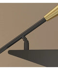 Close-up of No Drama Adjustable Wall Sconce With Chill Ambient Glow For Bedroom Bedside And Entryway's black and gold adjustable arm.