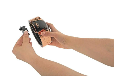 Hands holding Automatic Turkish Coffee Maker With Self Clean One Touch Brew And Easy Pour Altitude Auto Detect Technology For Consistent Flavor At Any Elevation USA 120V UL Listed Black And Silver in black and gold.