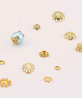Golden Filigree Flower Bead Caps Set With 240 Pcs 12 Unique Brass Petal Ends shown with beads for jewelry making