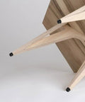 Non Slip Rubber Feet Pads For Tables And Cutting Boards shown on table legs with wood finish.