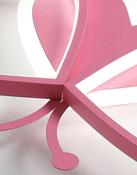 Close-up of pink butterfly shape on LED ceiling light fixture for kids room.