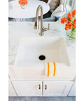 Touchless Single-Handle Pull-Down Kitchen Faucet With LED Light, Soap Dispenser, Hands-Free Sensor Sprayer In Stainless Steel installed over white sink