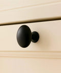 Installed Oval Matte Black Cabinet Knob on drawer 1.27 inch length 1.36 inch height by EAXINTA for modern kitchen and furniture