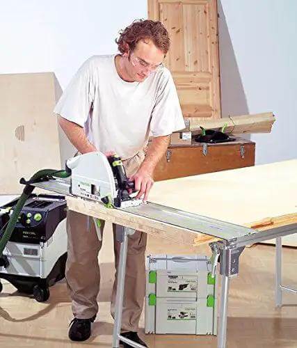 Man using Badass Zero Fuss Plunge Saw With Aluminum Track Guide on a workbench for accurate laminate cuts.