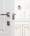Super Cool Adjustable Ball Door Catches With Roller Beads, pink brass latch installed on a white door, perfect for cupboards and closets.