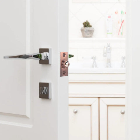 Super Cool Adjustable Ball Door Catches With Roller Beads, pink brass latch installed on a white door, perfect for cupboards and closets.