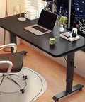 Premium Adjustable Standing Desk Featuring Smooth Manual Crank Height Adjustment And Secure Locking Casters Perfect For Gaming Stations And Daily Office Grinds While Delivering Top Tier Ergonomic Comfort In Matte Black, shown with laptop.