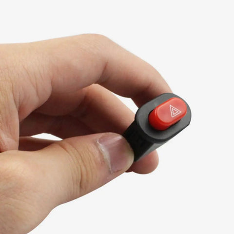 Hand holding a Double Flash Motorcycle Hazard Light Switch With Emergency Button Waterproof ABS Metal Controller for motorbikes.