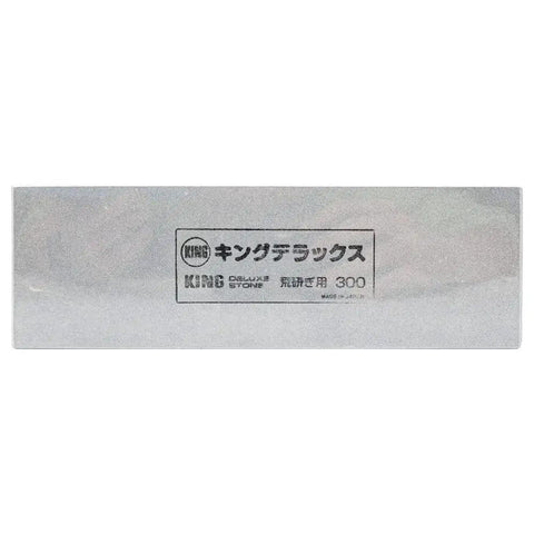 Front view of Rough Sharpening Stone 300 Grit Non Absorbent For Knives And Tools Eight Point One Inch By Two Point Six Inch By Thirteen Point Four Inch Gray Japan Made Pro Grade Durable Edge Sharpening Block For Heavy Duty Projects showcasing Japanese text and brand markings.