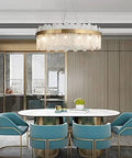Sleek Gold Glass Pendant Light Adjustable Led Hanging Fixture With Cyan Crystal For Living Room Prime Pick Home Glow Up Solid Setup And Chic Everyday Vibes above modern dining table with stylish blue chairs.