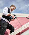 Person using Badass Cordless Drill Driver Featuring Ec Tec Brushless Motor High Torque Heavy Duty Power Tool on a sloped surface.