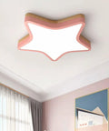 Star-shaped ceiling light in pink with flush mount in a modern room
