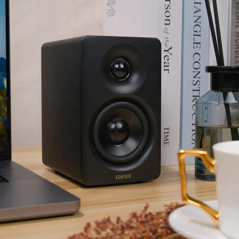 M60 Desktop Bluetooth Speaker System That Cranks Out 66W RMS, Hi Fi Audio, LDAC, shown on a desk beside a laptop.