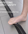 Foot stepping on 67 Inch Collapsible Shower Water Dam Barrier for Wet Dry Separation Keeps Water Inside Threshold in Bathrooms and Kitchens