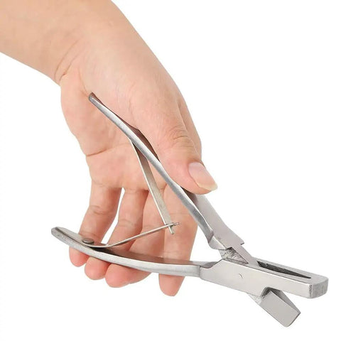 Hand holding stainless steel pig ear tag pliers for farm animals identification tool V shape lightweight and durable