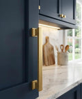 Gold Champagne Cabinet Pulls 10 Pack Four Inch Center-to-Center Dope Contemporary Hardware Handle For Kitchen And Bath Includes Mounting Screws Overall Length About Five Inches Half Inch Wide One Inch Projection on dark cabinet.