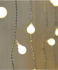Close-up of Fairy Curtain Lights USB Powered And Battery Operated 13ft 96 LED Globe Icicle String with warm white glow