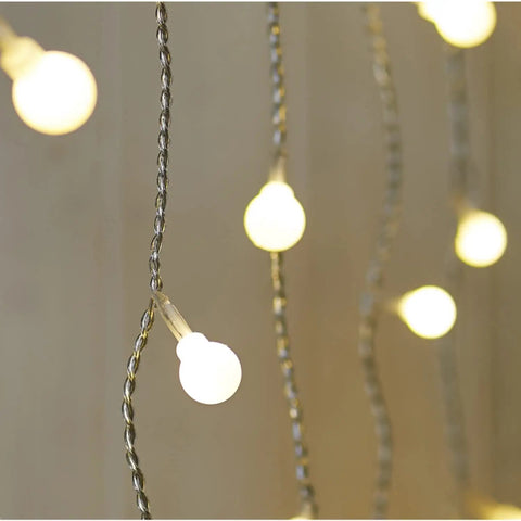 Close-up of Fairy Curtain Lights USB Powered And Battery Operated 13ft 96 LED Globe Icicle String with warm white glow