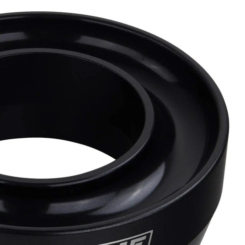 Close-up of T6 billet aluminum coil spring lift spacer from 2.5 Inch Front Leveling Kit For 1999-2007 Chevrolet Silverado 1500 And GMC Sierra 1500 2WD