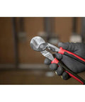 Pro Grade Journeyman High Leverage Cable Cutter And Wire Stripper For Aluminum Copper And Communications Cable held in gloves
