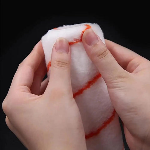 Hands holding a 10-inch microfiber foam paint roller from the 8Pcs 10 Inch Paint Rollers for Smooth Wall Makeover and Fresh Pattern Textures.