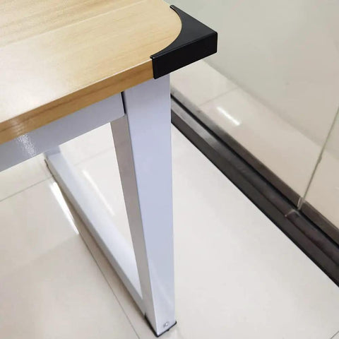 Heavy Duty Black Metal Corner Protectors Four Piece Set protecting furniture edge, featuring sleek black steel design on wooden table.