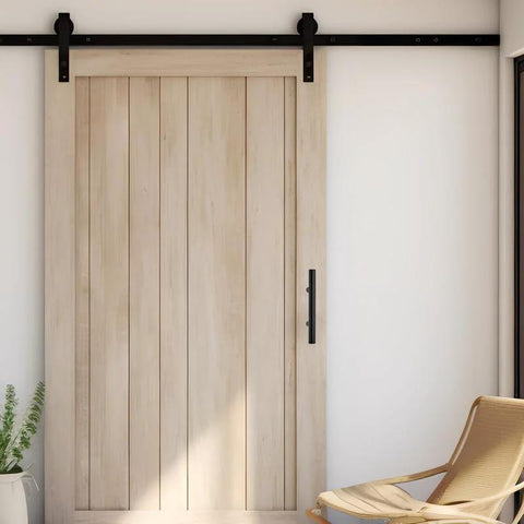 Wooden sliding barn door with matte black handle and track in modern interior