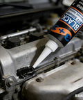 Close-up of black RTV silicone gasket maker dispensed onto an engine valve cover