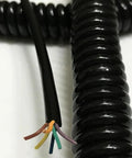 Hella Flexible Coiled Extension Cord With Spiral Spring Design For Rapid Retracting And Zero Tangle Stress Fast Six Core Data Charging Cable. Close-up of black coiled wire with exposed six conductor ends.