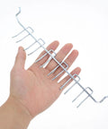Hand holding metal Two Pack Adjustable Iron Storage Hooks Heavy Duty Pegboard Tool Hangers for Garage Workshop Home Office Organization.